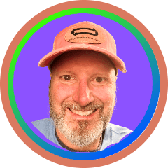 Smiling bearded man in orange baseball cap, community logo for Creator Kashflow Circle with colorful circular border